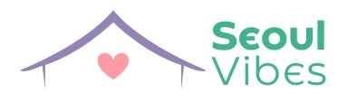 Logo da loja Seoul Vibes. Há o contorno de uma casinha na cor roxa e dentro um coração rosa. Ao lado direito está escrito Seoul Vibes na cor verde.